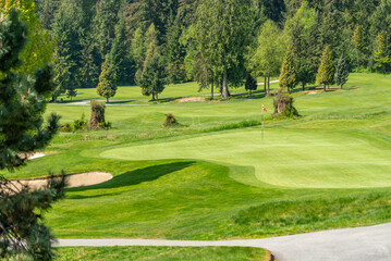 Obraz premium Golf course with gorgeous green and fantastic forest view in Vancouver, Canada, North America. Day time on April 2025.