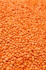 Raw red lentils as background, closeup view