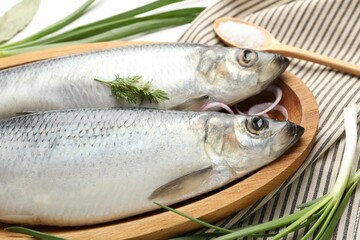 Salted herrings, green onions, dill and salt on table, closeup