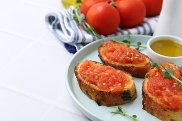 Tasty bread with tomatoes, microgreens and oil on white table, closeup. Space for text