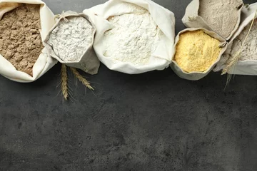 Fototapete Rund Different types of flour in bags on grey table, flat lay. Space for text © New Africa