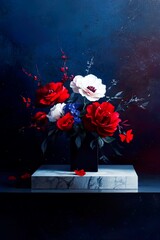Vibrant red and white flowers in black vase against dark blue background