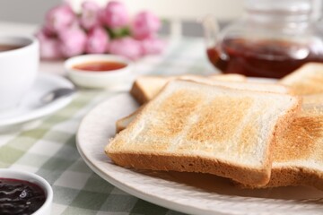 Tasty crispy toasted bread slices on table, closeup