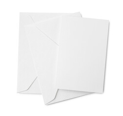Blank greeting card and paper envelopes on white background, top view
