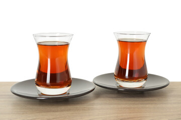 Tasty Turkish tea in cups on wooden table against white background