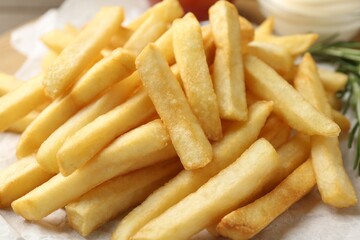 Fresh tasty french fries on table, closeup