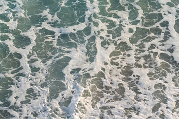 Foamy waves on the sea surface