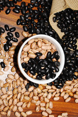 Top view of a bowl with beans. Brazilian grains. Carioca and black beans.