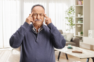 Man at home suffering from headache