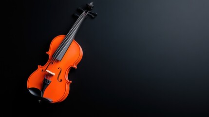 Fototapeta premium Classic wooden violin lying diagonally on a dark matte background with copy space.