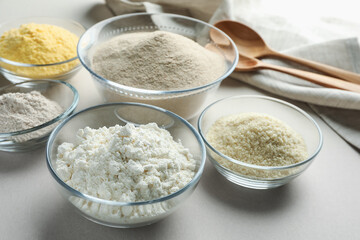 Different types of flour on white background, closeup