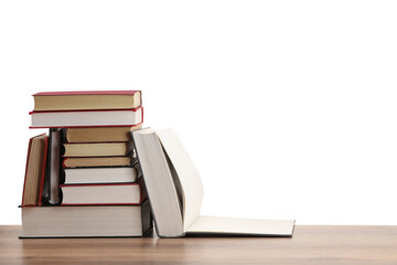 Many old books on wooden table against white background