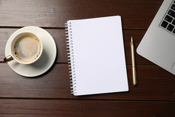 Notebook, pen, coffee and laptop on wooden table, flat lay