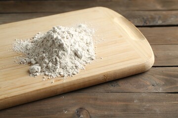 Pile of flour on wooden table, closeup