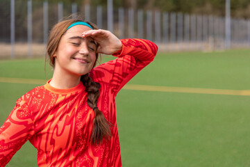 Girl soccer player. Girl in sports uniform on the soccer field. Football concept.