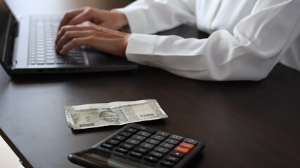 Close up view of woman's hands and Indian rupee (INR) banknotes. Concept of bank office work, saving money for retirement, cash settlement, financial success, literacy and income planning in India. 