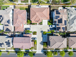 Top Down Aerial Photo over a suburban home in California with solar, cars, streets, trees, and roads.