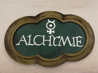 Weathered stone tablet with alchemy pictogram and inscription “ALCHYMIE” set into a medieval...