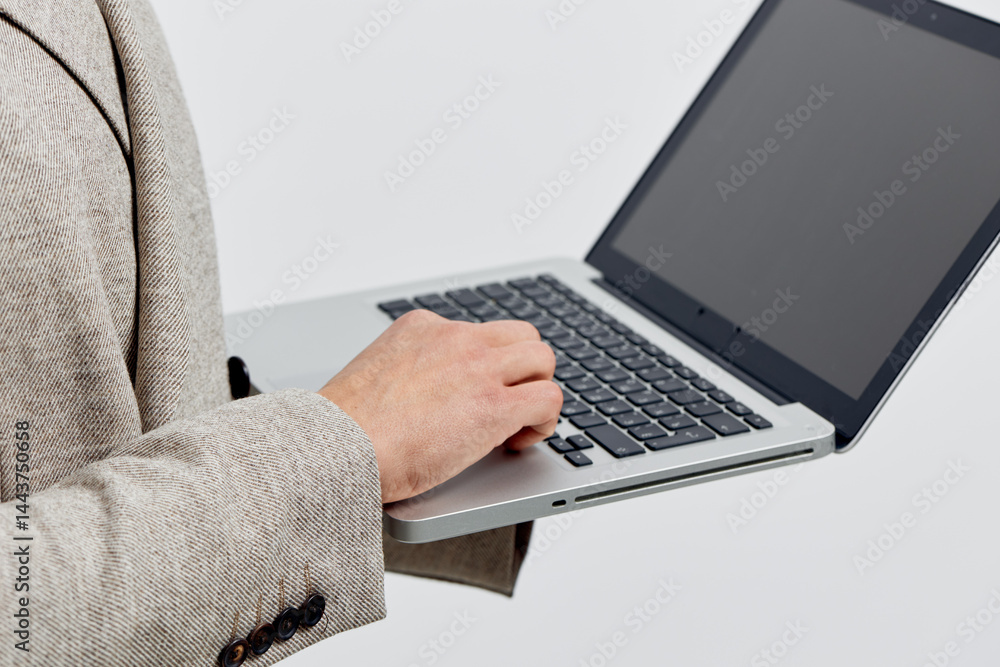 Poster man holding laptop work hand close up typing on keyboard wearing beige jacket isolated background di