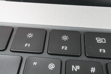 Close-up image of a laptop keyboard, featuring function keys F1-F3 Sharp focus suggests its the main point of interest for technology marketingadvertising