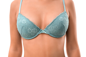 Young woman in blue bra on white background, closeup