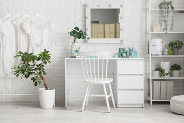 Interior of makeup room with table, clothes rack and shelf unit