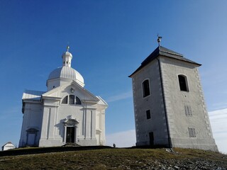 Chapel on Svaty Kopecek hill above Mikulov surrounded by grass and walking trail in scenic...