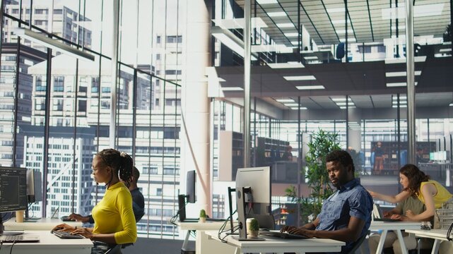 African american man designing, developing and maintaining software applications using various programming languages. System administrator debugging company servers, preventing failures, camera B