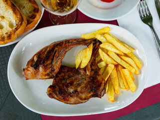 Spanish dish of fried rabbit and French fries.