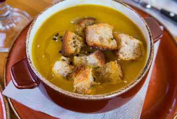 Delicious pureed vegetarian soup served with crispy croutons in clay tureen..