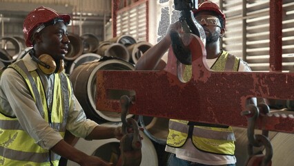 Engineering and worker training or explaining detail weight overhead cranelifting machine, two engineer checking the operation of crane in the factory, recruitment concept