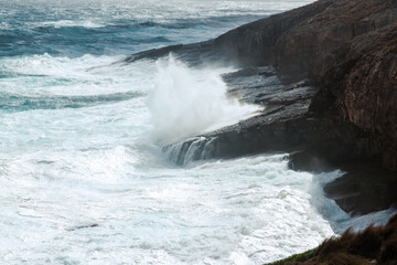 wild seas crashing against rocky coastline on Kangaroo Island, Australia