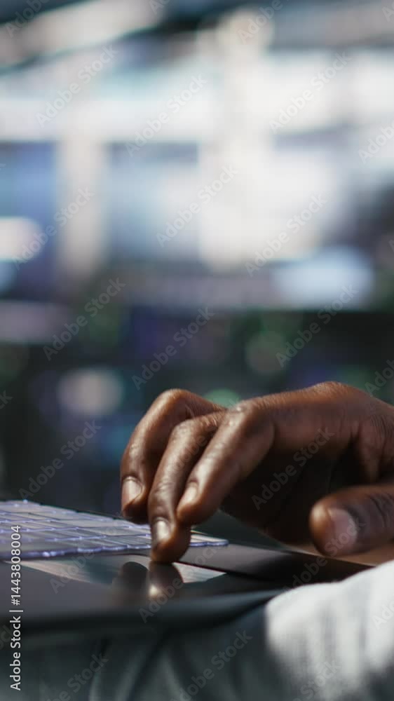 Poster vertical video close up of data center worker using laptop to interpret ai generated data analytics 