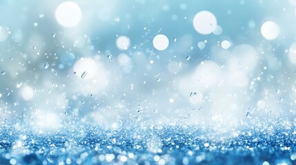 Soft blue bokeh background with sparkling water droplets creating a dreamy atmosphere