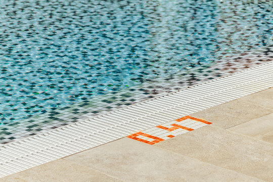 Swimming pool edge with mosaic tile pattern