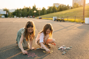 Children Drawing with Chalk on a Sunny Day in the Park of the City