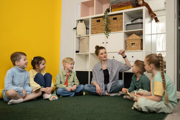 Children Engaged in Creative Group Lesson with Teacher