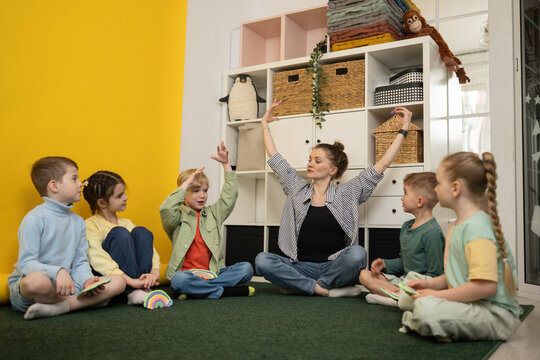 Teacher Engaging Children in Creative Classroom Activities