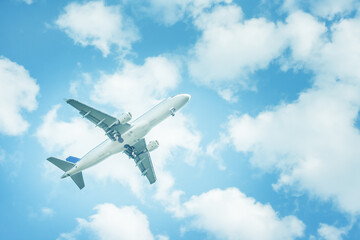 Airplane flying in cloudy sky