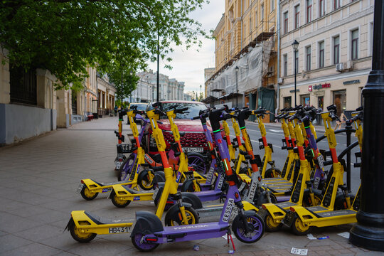 Kicksharing system electric scooters are parked on the street in Moscow historic city center at daytime