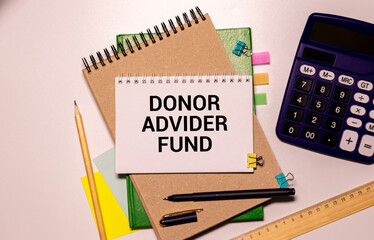 Home office workplace with clipboard and pen with DONOR ADVIDER FUND text