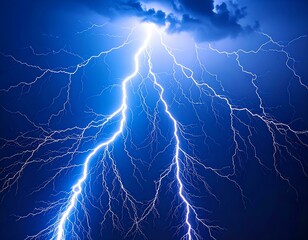 Fototapeta premium Dramatic lightning strike across dark blue sky. Powerful, branched bolt of lightning.
