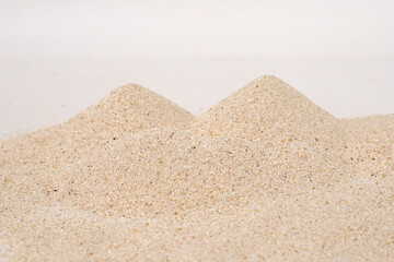 Heap of dry beach sand on white background