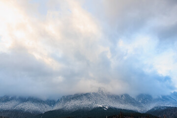 Cloudy sky over snow-capped mountain range at dusk
