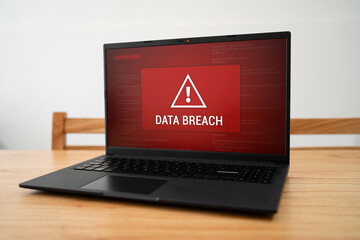 Urgent data breach notification on corporate laptop. Concept of being hacked and cyber crime.