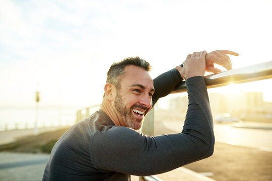 Happy man, thinking or resting on running break for outdoor exercise, fitness workout or cardio training. Fatigue, tired or runner with smile in practice for health, recovery or sports performance