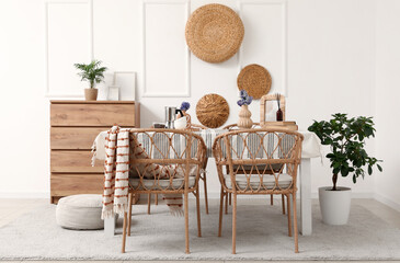Dining table with hyacinth flowers and coffee in light room interior