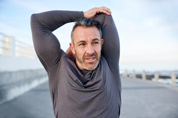 Fitness, mature man and stretching outdoor for workout preparation, getting ready and muscle...