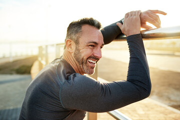 Happy, running and man in morning rest for exercise, marathon training and cardio workout in town. Sports, sunshine and person for wellness, health and recovery for performance, endurance and fitness