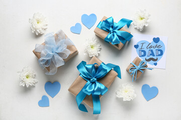 Postcard with gift boxes, flowers and hearts for Father's Day on white grunge background